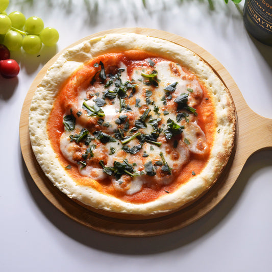 斜め上から撮影された、トマトソースにモッツァレラチーズとバジルがトッピングされているローマ風ピザ